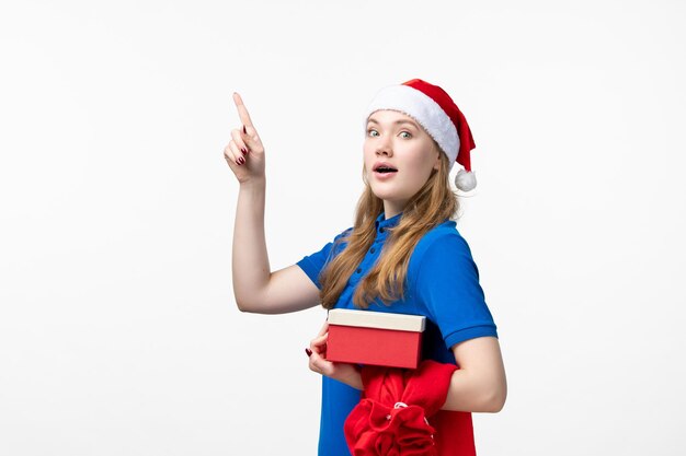 Front view of female courier with holiday present on white wall