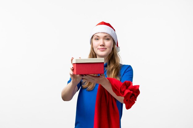Front view of female courier with holiday present on white wall