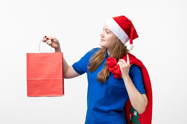 Front view of female courier with little present on white wall