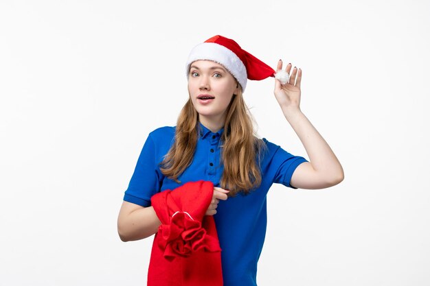 Front view of female courier with present bag on a white wall