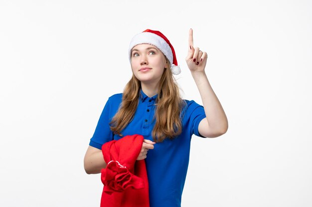 Front view of female courier with present bag on the white wall