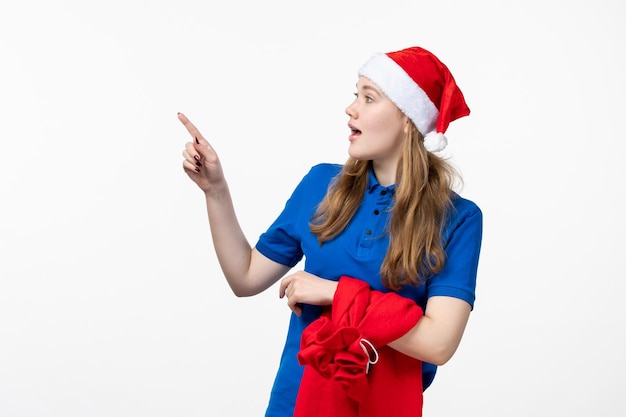 Front view of female courier with present bag on white wall