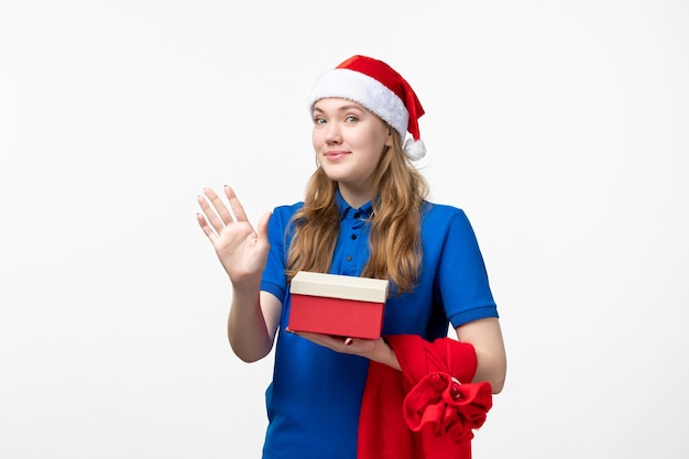 Front view of female courier with present on a white wall