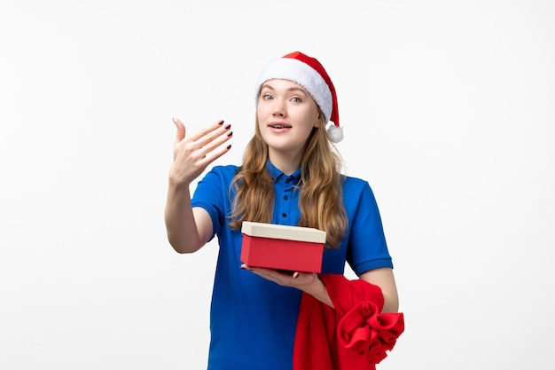 Front view of female courier with present on the white wall