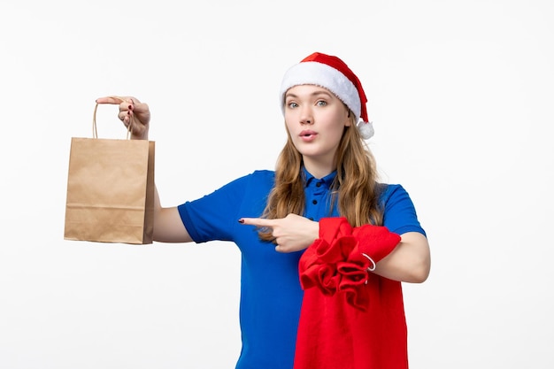 Front view of female courier with present on white wall