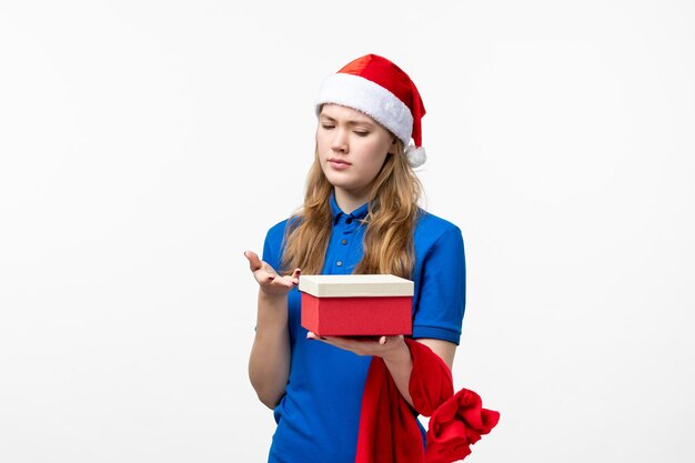 Front view of female courier with present on white wall