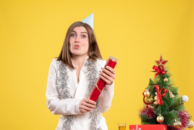 Front view female doctor blowing firecracker