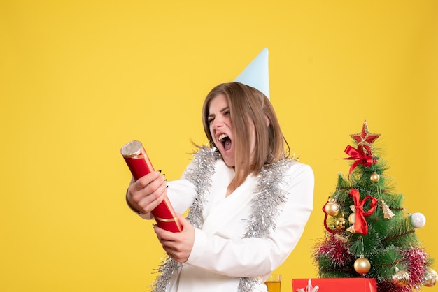 Free photo front view female doctor blowing firecracker