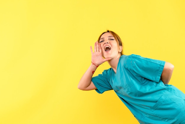 Front view female doctor calling on yellow space