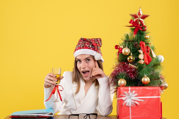 Front view female doctor celebrating xmas with champagne