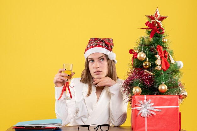 Front view female doctor celebrating xmas with champagne