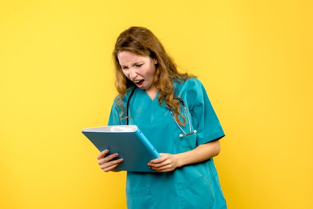 Front view female doctor displeased on yellow space