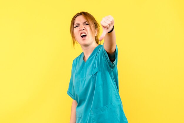 Front view female doctor displeased on yellow space