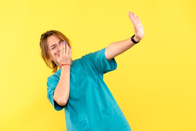 Front view female doctor displeased on yellow space