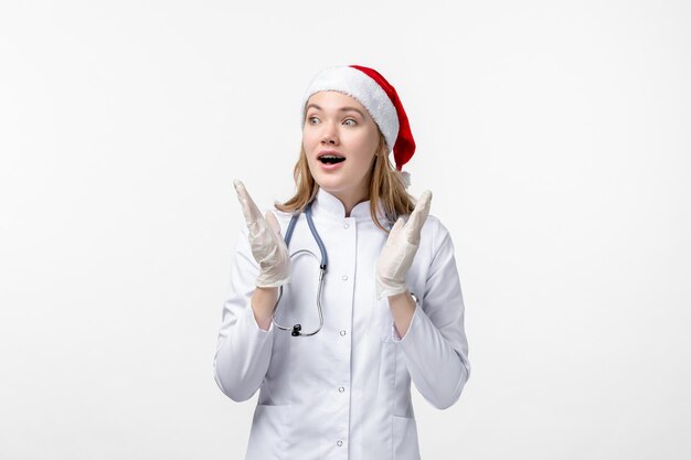 Front view of female doctor excited on white wall