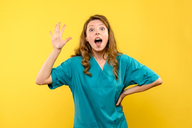 Front view female doctor excited on a yellow space