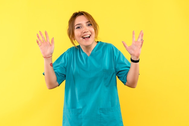 Front view female doctor excited on yellow space