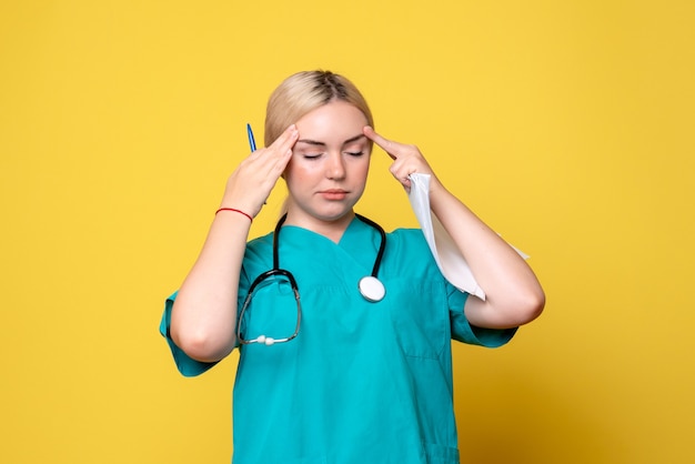 Front view female doctor holding analysis and papers having headache, coronavirus health medic covid nurse hospital