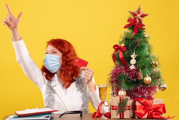 Front view female doctor holding bank card