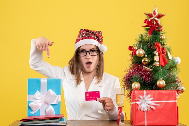 Front view female doctor holding bank card