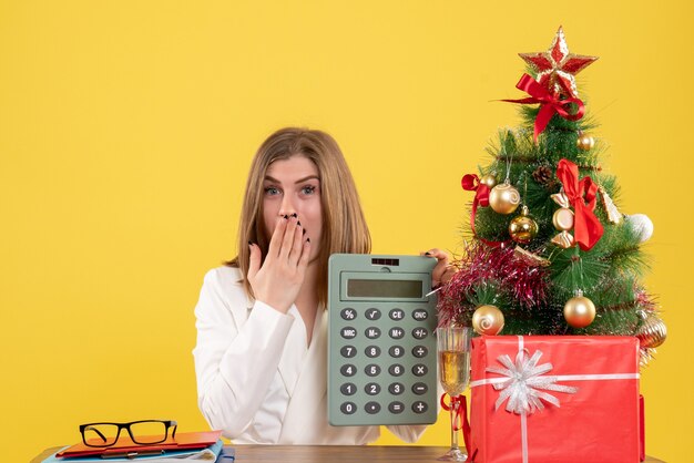 Front view female doctor holding calculator