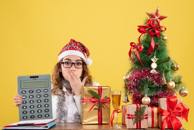 Front view female doctor holding calculator