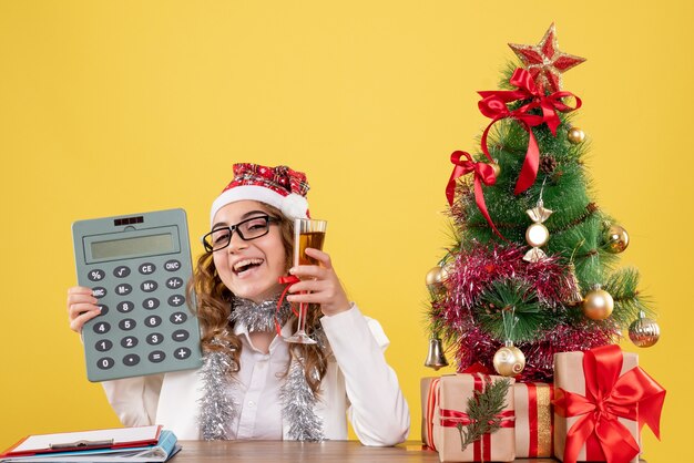 Front view female doctor holding calculator