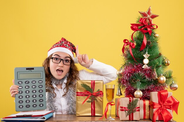 Front view female doctor holding calculator