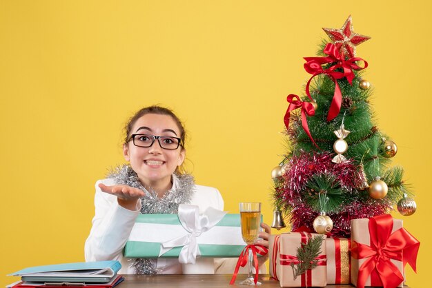 Front view female doctor holding christmas present