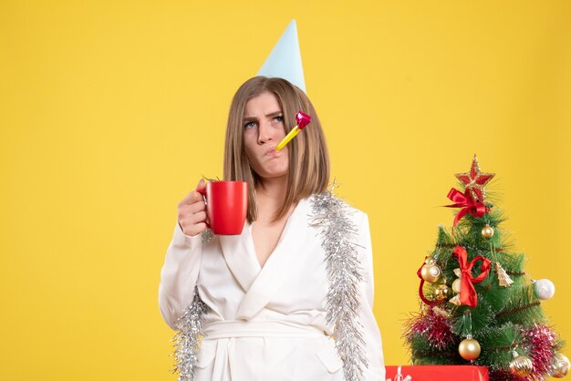 Front view female doctor holding cup of tea