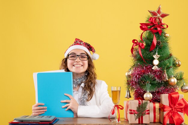 Front view female doctor holding different files