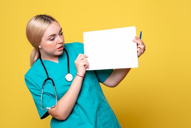 Front view female doctor holding different papers, pandemic health medic covid-19 hospital nurse virus