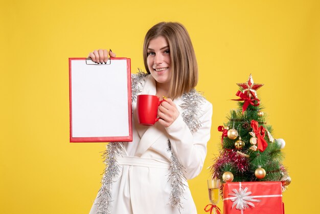 Front view female doctor holding file note and cup of tea