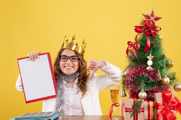 Front view female doctor holding file note with crown