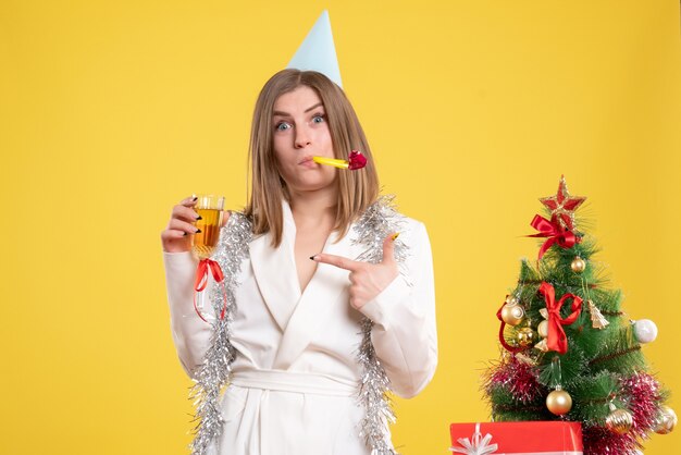 Front view female doctor holding glass of champagne