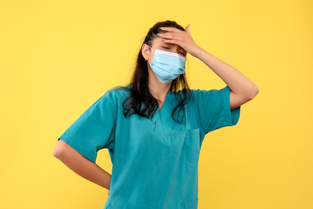 Front view female doctor holding her back and head standing