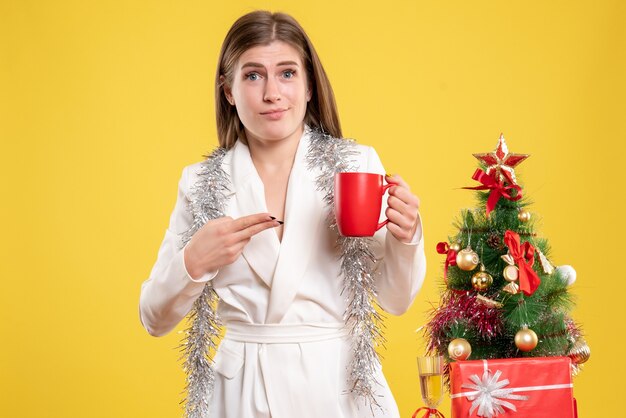 Front view female doctor holding hot cup of tea