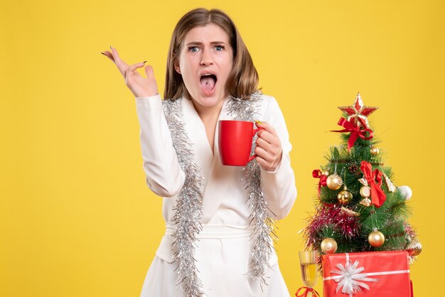 Front view female doctor holding hot cup of tea