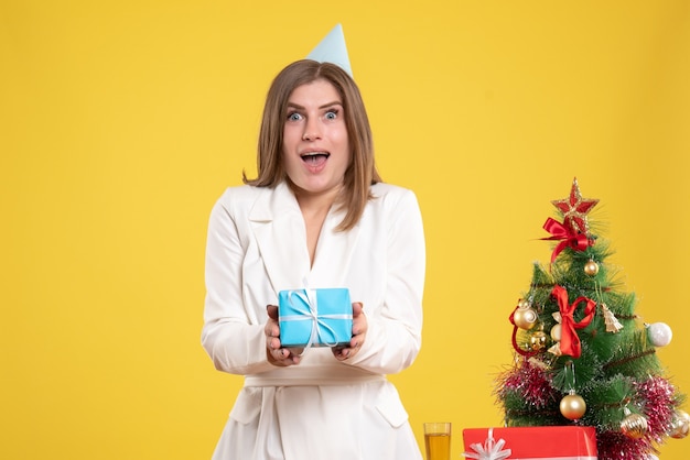 Front view female doctor holding little present