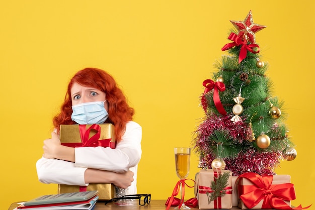 Front view female doctor holding present