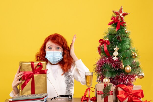 Front view female doctor holding present