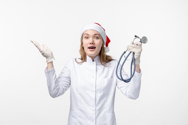 Free photo front view of female doctor holding stethoscope on white wall