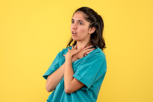 Front view female doctor holding throat standing