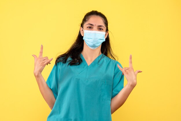 Front view female doctor making rock sign with both hands