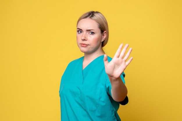 Front view female doctor in medical shirt asking to stop, medic emotion nurse hospital covid pandemic