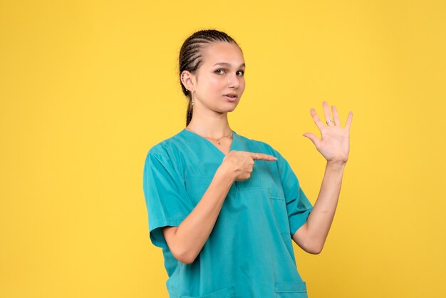 Front view female doctor in medical shirt, color hospital nurse covid-19 health virus