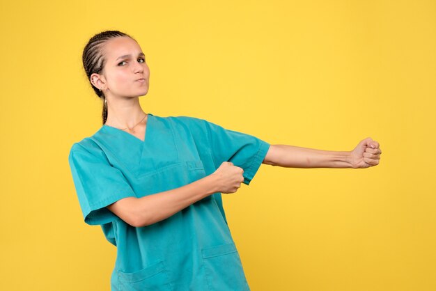 Front view female doctor in medical shirt, color hospital nurse covid-19 virus