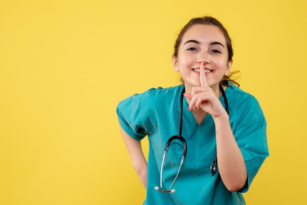 Front view female doctor in medical shirt, colors virus covid-19 uniform health emotion