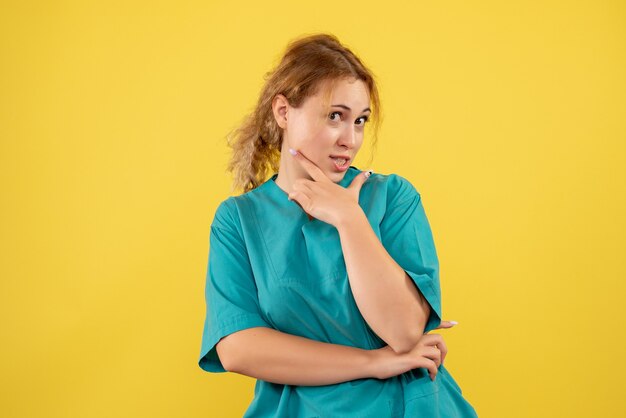 Front view female doctor in medical shirt, covid-19 nurse color health medic