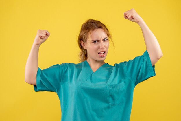 Front view female doctor in medical shirt flexing, color hospital nurse covid health medic